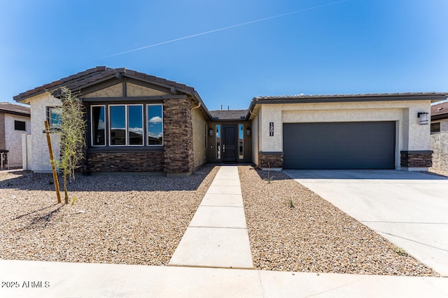 1301 W Via De Olivos, Queen Creek, AZ 85140 - view of front of home featuring stone siding, concrete driveway, a garage, and stucco siding
