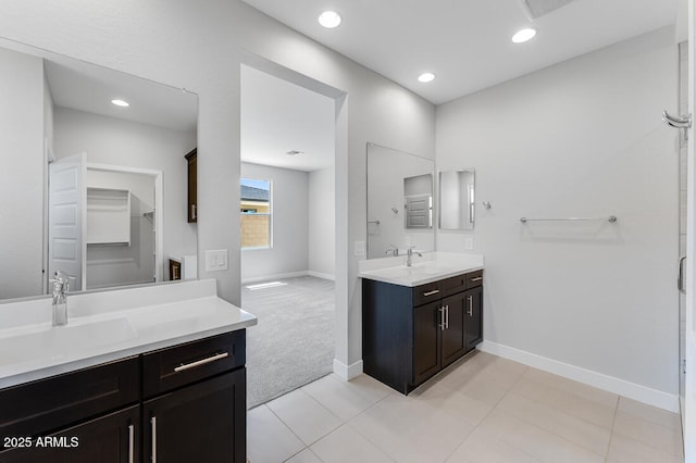 1301 W Via De Olivos, Queen Creek, AZ 85140 - bathroom with two vanities, baseboards, recessed lighting, and tile patterned flooring