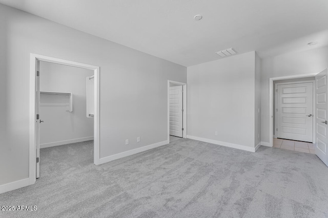 1301 W Via De Olivos, Queen Creek, AZ 85140 - unfurnished bedroom with carpet floors, baseboards, and a walk in closet