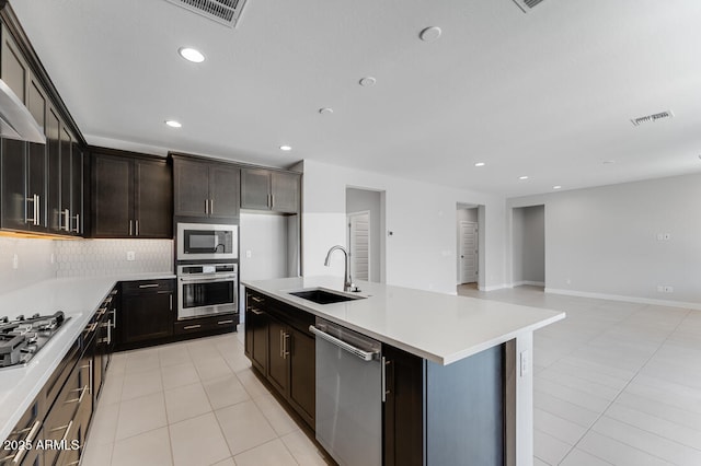 1301 W Via De Olivos, Queen Creek, AZ 85140 - kitchen with stainless steel appliances, a sink, light countertops, decorative backsplash, and recessed lighting