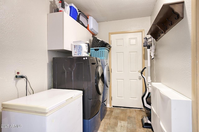 3203 W Libby St, Phoenix, AZ 85053 - washroom featuring washing machine and clothes dryer, light wood-style flooring, and a textured wall