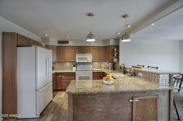 3203 W Libby St, Phoenix, AZ 85053 - kitchen with white appliances, a peninsula, open shelves, decorative backsplash, and light stone counters