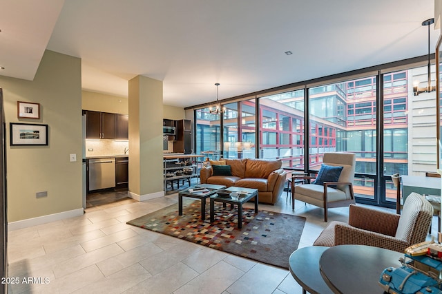 living room with light tile patterned floors, floor to ceiling windows, and a chandelier