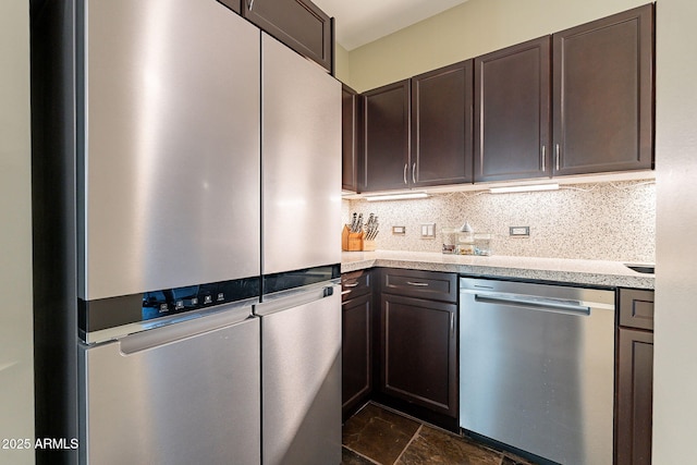 kitchen with appliances with stainless steel finishes, dark brown cabinets, and backsplash