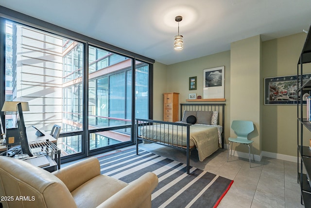 bedroom featuring expansive windows and light tile patterned floors