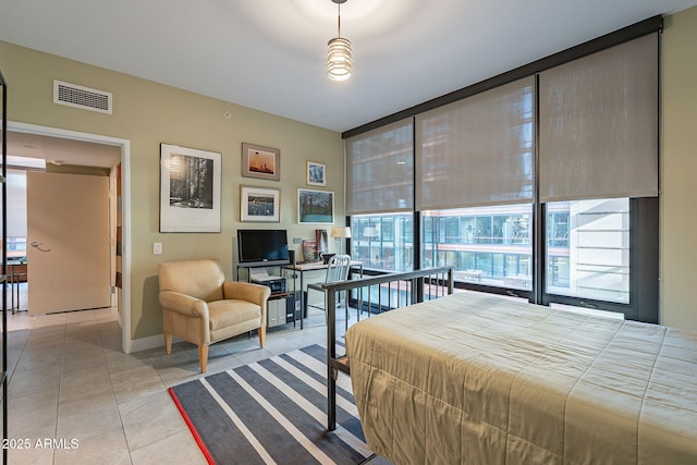 tiled bedroom featuring floor to ceiling windows