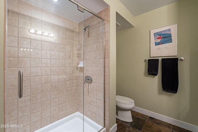 bathroom featuring a shower with door and toilet