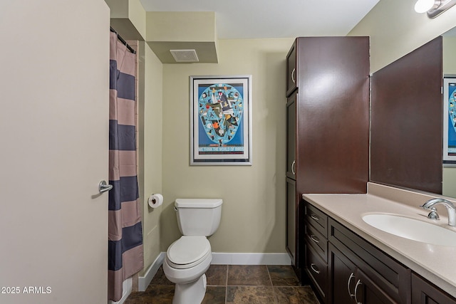 bathroom with vanity, curtained shower, and toilet