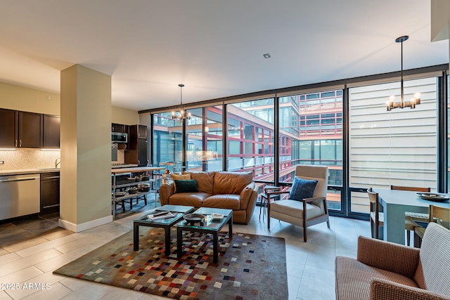 living room with expansive windows, sink, and a notable chandelier