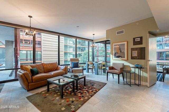 tiled living room featuring a notable chandelier and floor to ceiling windows