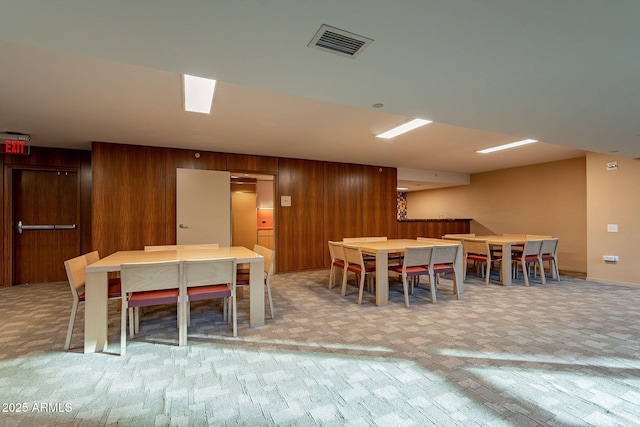 dining room featuring wood walls