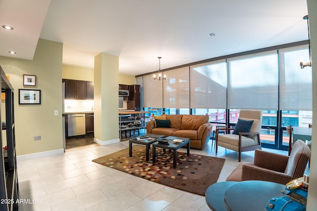 tiled living room with expansive windows and a chandelier