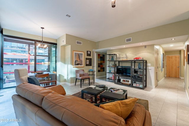 living room with light tile patterned flooring and a notable chandelier