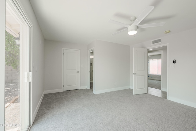 spare room featuring ceiling fan and light carpet