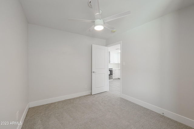 spare room with light carpet and ceiling fan