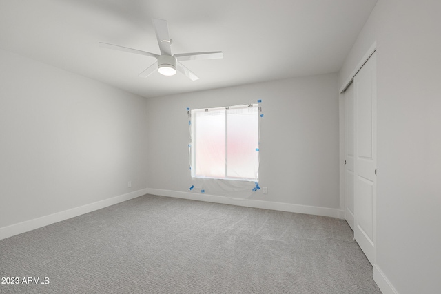 empty room with ceiling fan and carpet flooring