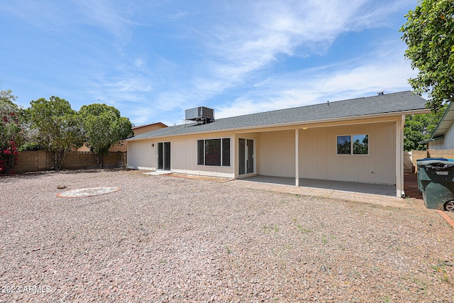 rear view of property with a patio and central AC