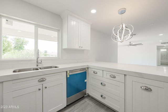 kitchen with stainless steel dishwasher, decorative light fixtures, white cabinetry, ceiling fan, and sink