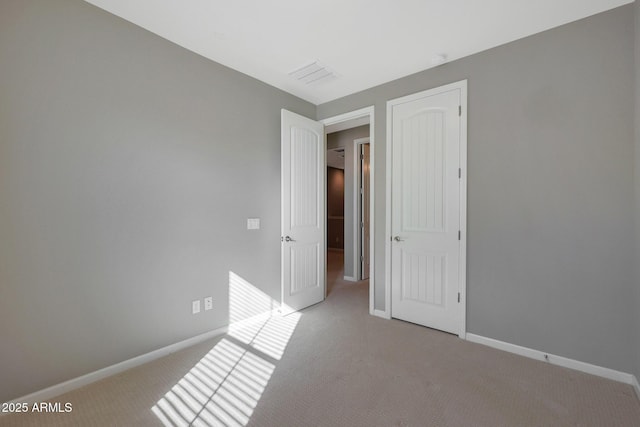 unfurnished bedroom featuring light colored carpet