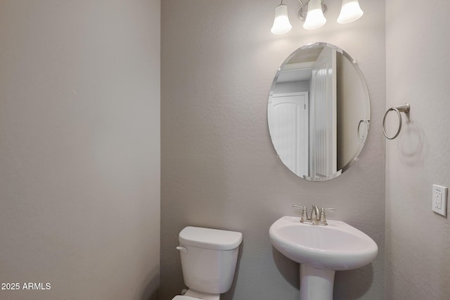 bathroom featuring sink and toilet