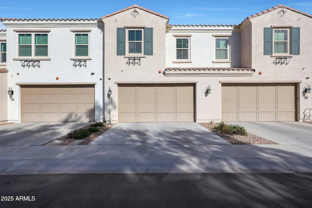 mediterranean / spanish-style home with a garage