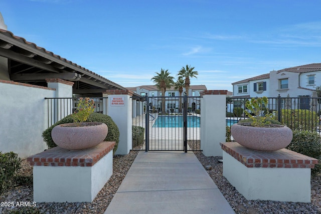 view of gate with a community pool