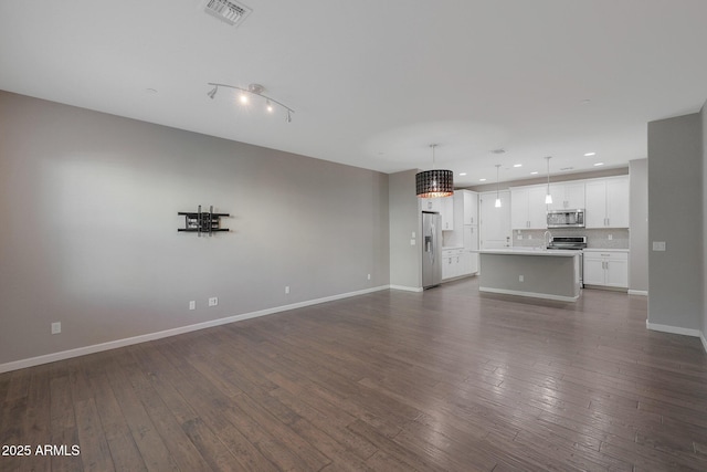 unfurnished living room featuring dark hardwood / wood-style flooring