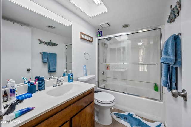 4136 W Hearn Rd, Phoenix, AZ 85053 - bathroom featuring toilet, vanity, and bath / shower combo with glass door