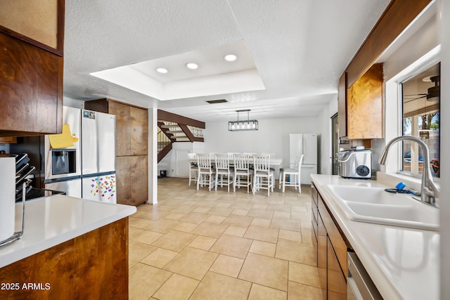 4136 W Hearn Rd, Phoenix, AZ 85053 - kitchen with a sink, a raised ceiling, fridge with ice dispenser, light countertops, and recessed lighting
