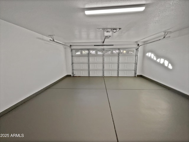 garage with a garage door opener and baseboards