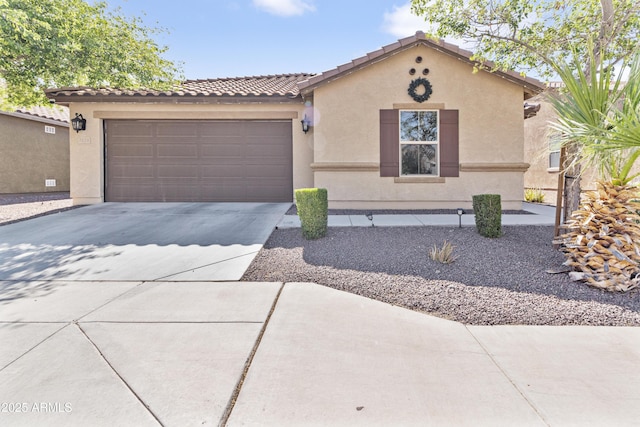 7575 W Darrel Rd, Laveen, AZ 85339 - mediterranean / spanish house featuring concrete driveway, a tile roof, stucco siding, and an attached garage