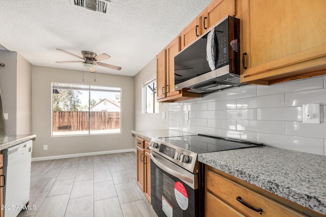 7506 W Sells Dr, Phoenix, AZ 85033 - kitchen with stainless steel appliances, baseboards, tasteful backsplash, and a ceiling fan