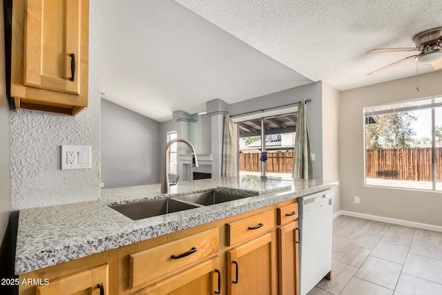 7506 W Sells Dr, Phoenix, AZ 85033 - kitchen with dishwasher, a sink, light stone countertops, a ceiling fan, and a textured ceiling