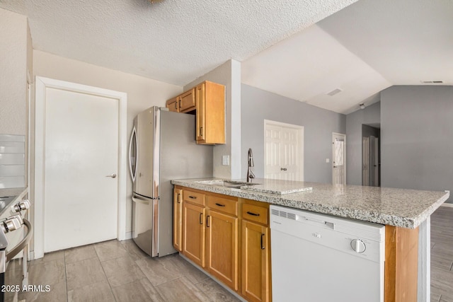 7506 W Sells Dr, Phoenix, AZ 85033 - kitchen featuring white dishwasher, a peninsula, a sink, stove, and lofted ceiling