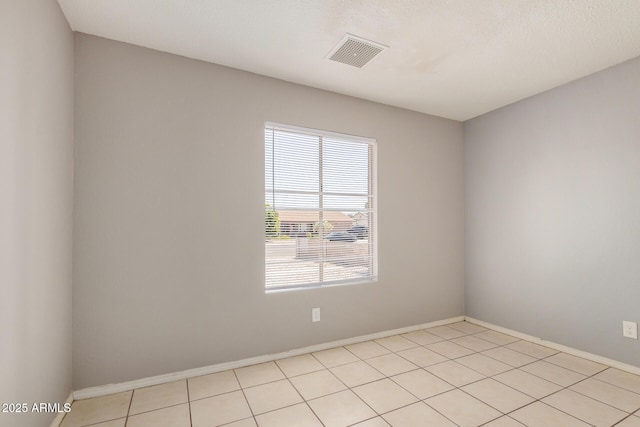 7506 W Sells Dr, Phoenix, AZ 85033 - spare room featuring baseboards and light tile patterned floors