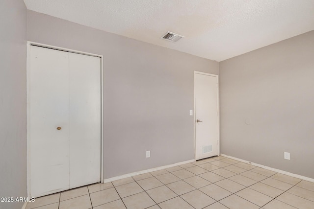 7506 W Sells Dr, Phoenix, AZ 85033 - unfurnished bedroom featuring a closet, baseboards, and a textured ceiling