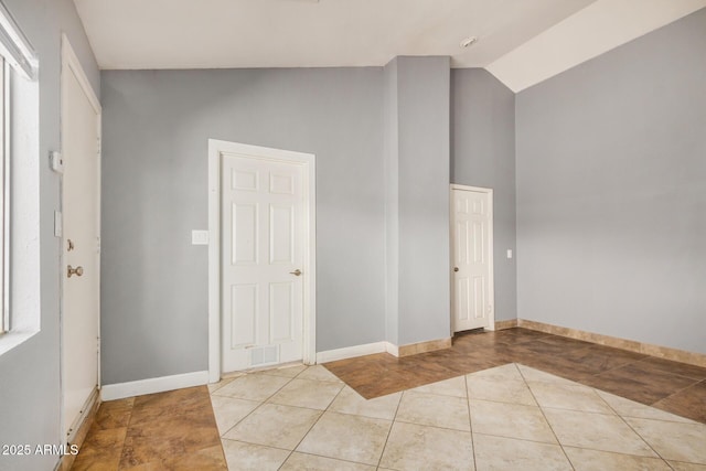 7506 W Sells Dr, Phoenix, AZ 85033 - foyer featuring light tile patterned floors, baseboards, and high vaulted ceiling