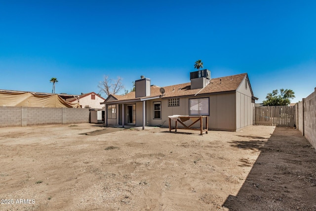 7506 W Sells Dr, Phoenix, AZ 85033 - rear view of house featuring a chimney, a fenced backyard, roof with shingles, and a patio