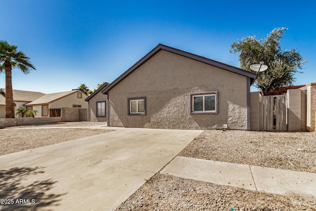 7506 W Sells Dr, Phoenix, AZ 85033 - view of front of house featuring stucco siding, a gate, and a patio area