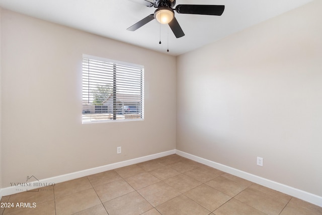 tiled spare room featuring ceiling fan