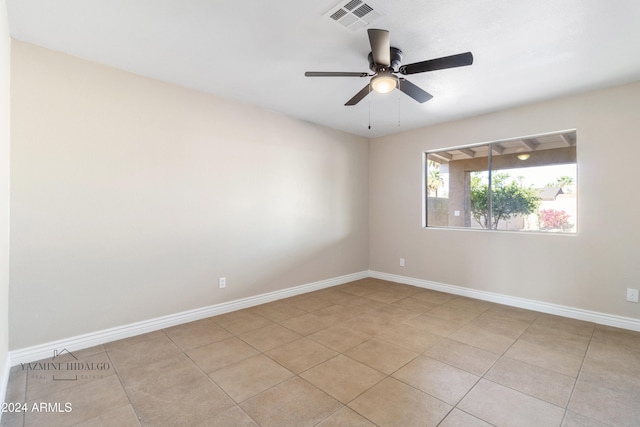 unfurnished room featuring ceiling fan and light tile patterned floors