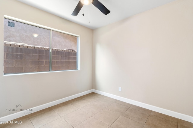 unfurnished room featuring light tile patterned floors and ceiling fan