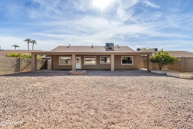 rear view of house featuring a patio area and cooling unit