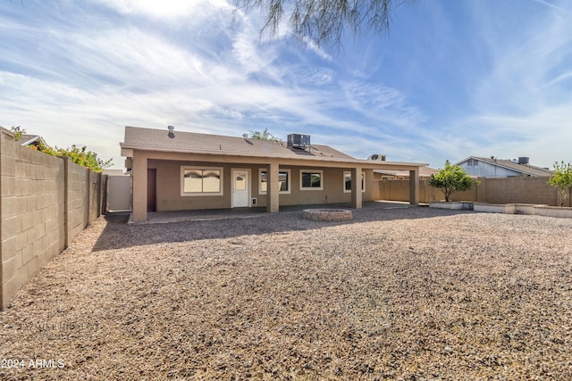 rear view of property featuring central AC