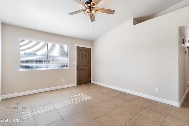 unfurnished room featuring light tile patterned floors, ceiling fan, and lofted ceiling