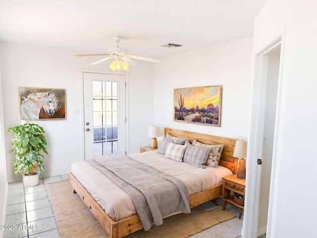 bedroom featuring ceiling fan, light tile patterned floors, and access to outside