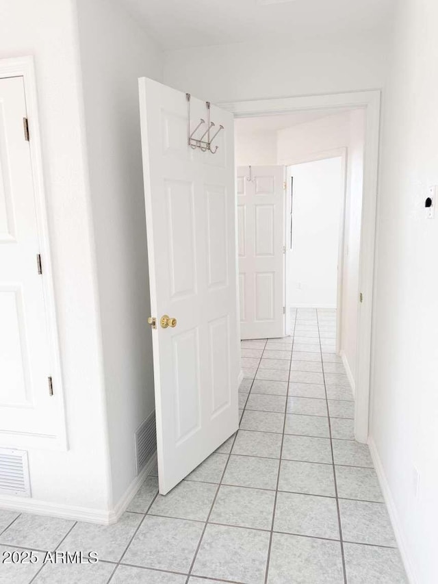 hallway featuring light tile patterned floors