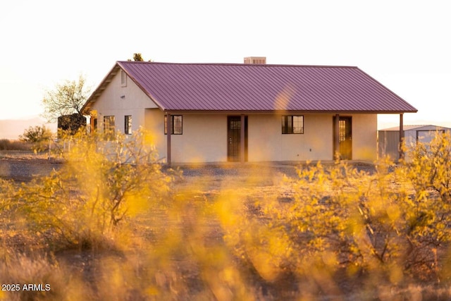 view of back house at dusk