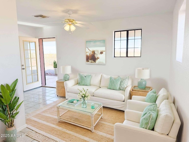 living room with tile patterned floors and ceiling fan