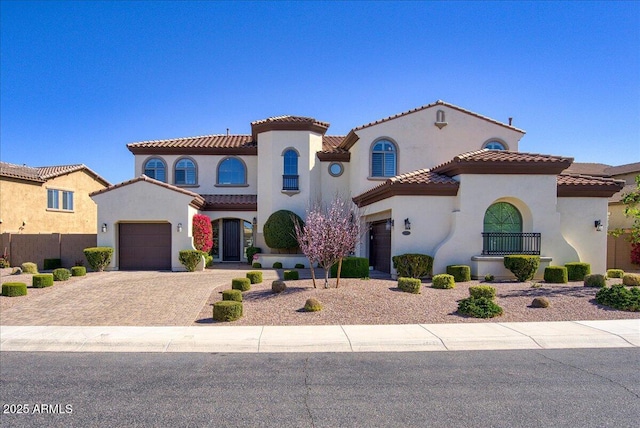 mediterranean / spanish-style home with a garage